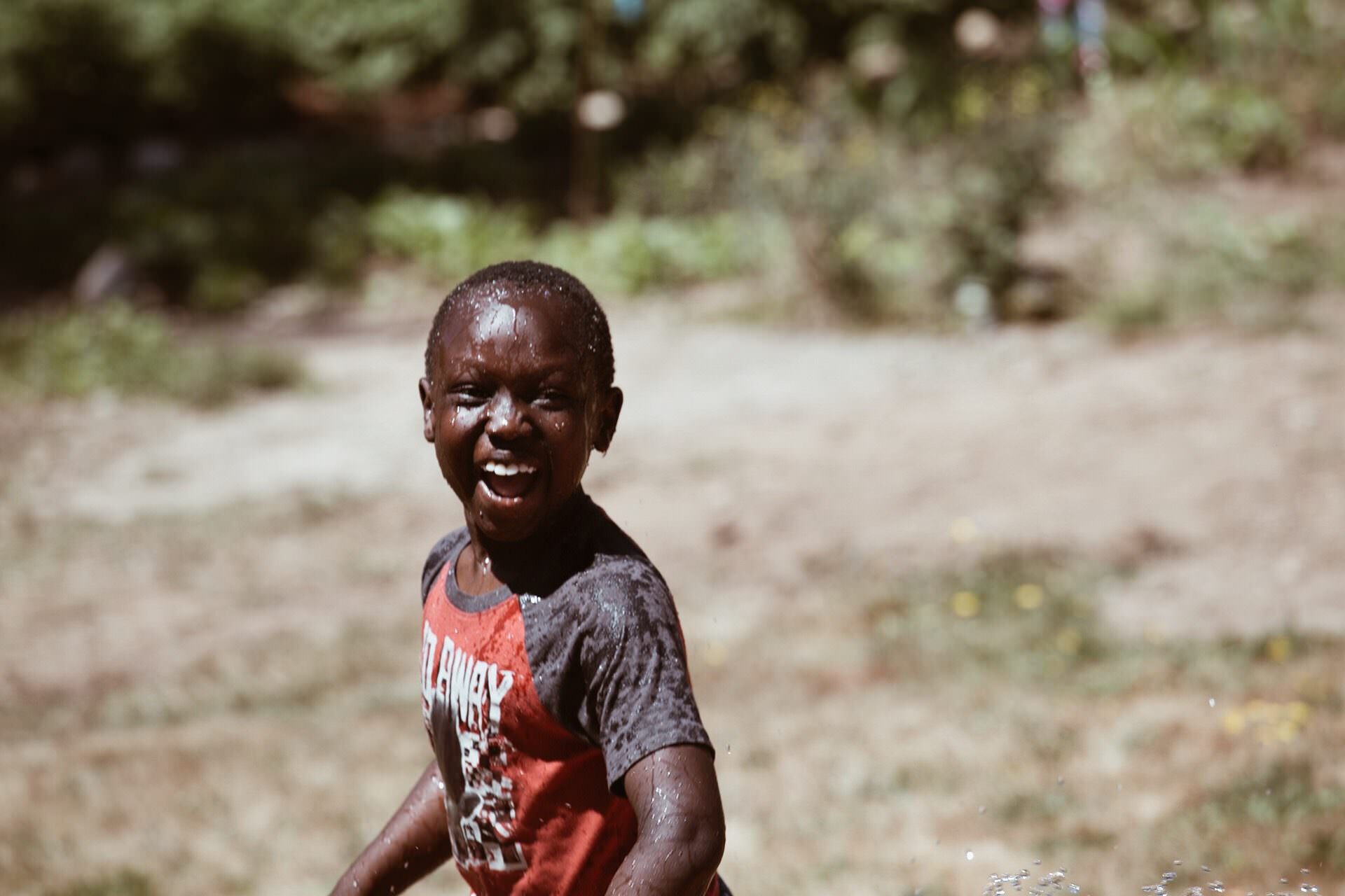 Boy with water on face