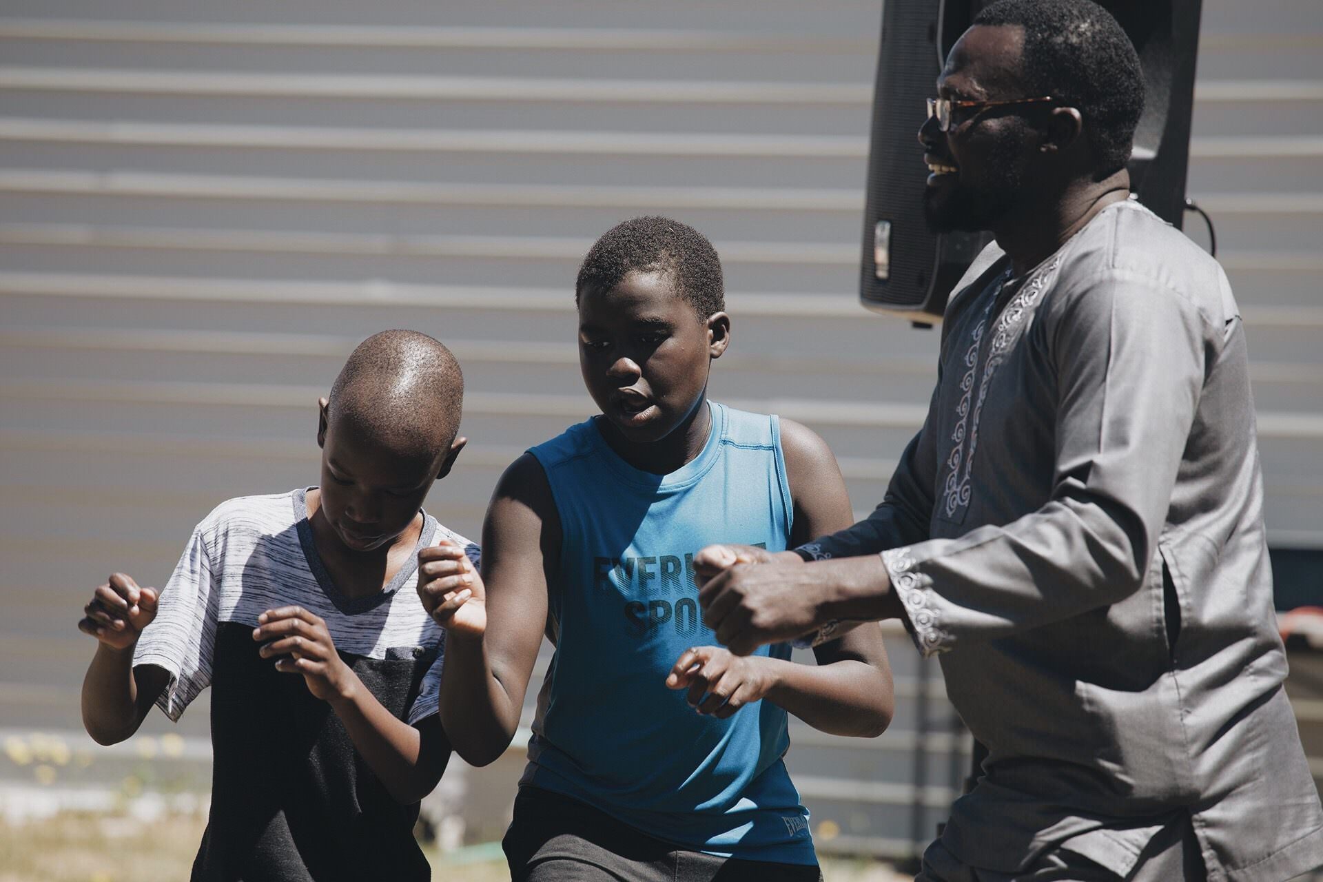 Man and two boys dancing