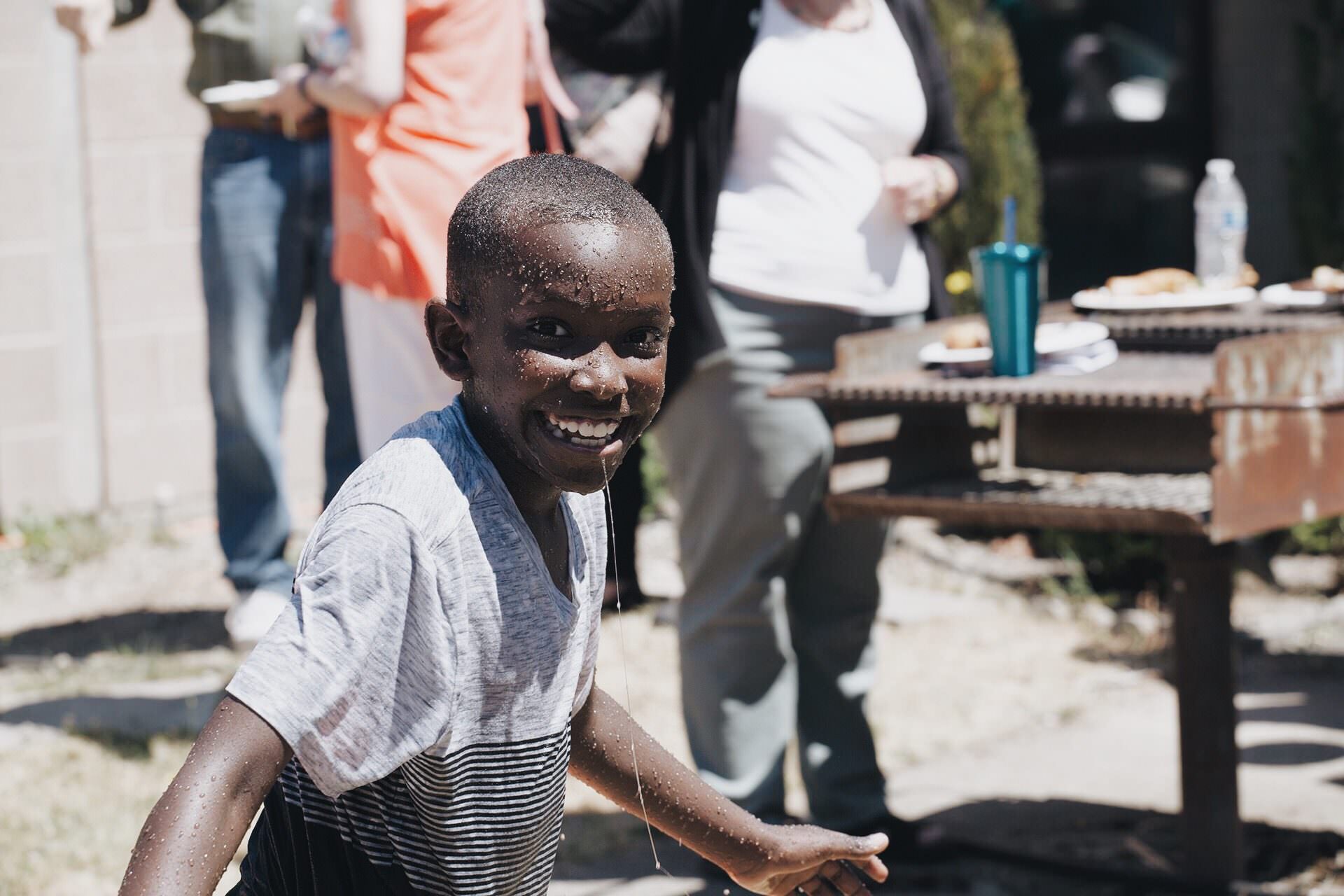 Smiling boy with water on face