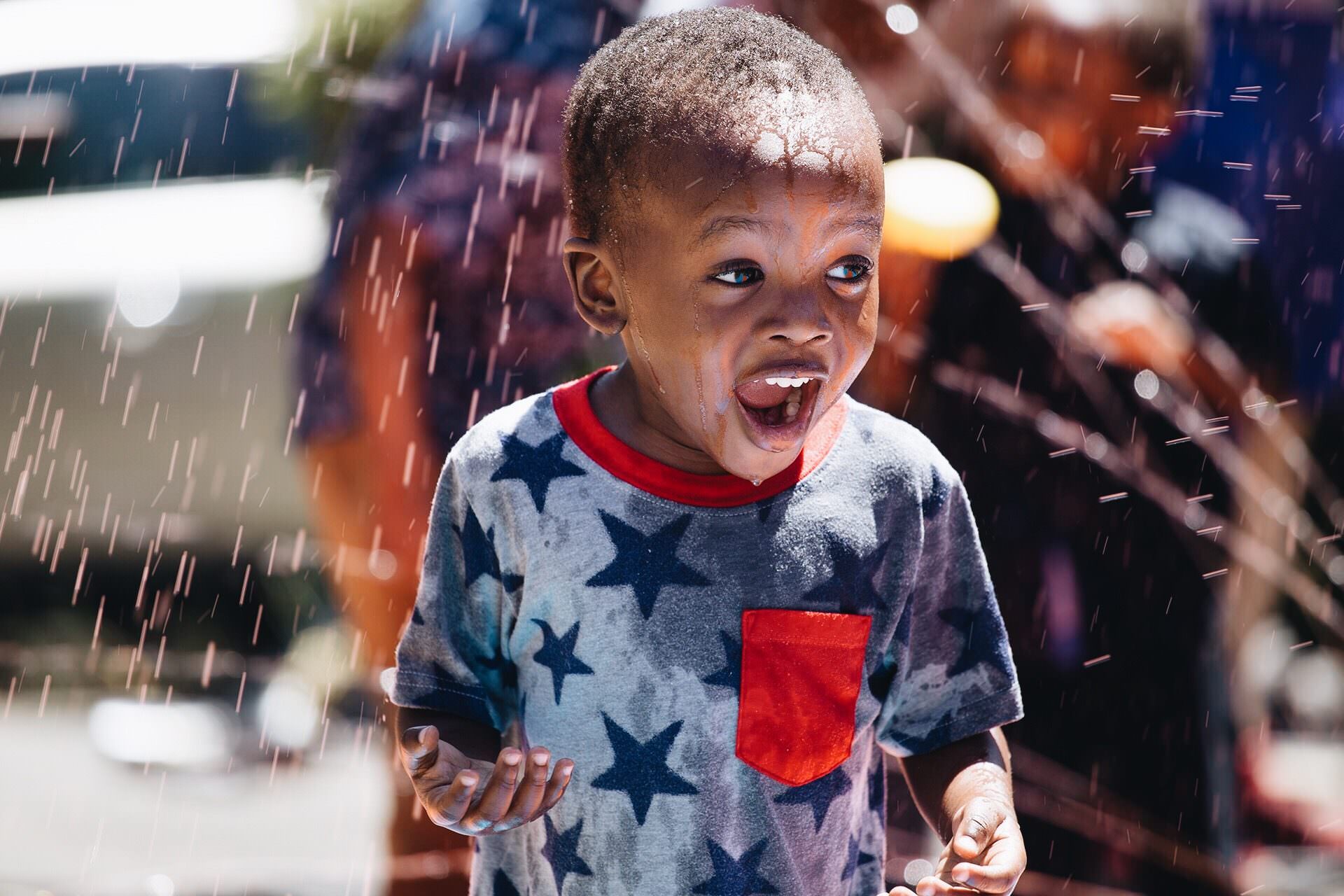 Boy in sprinkler