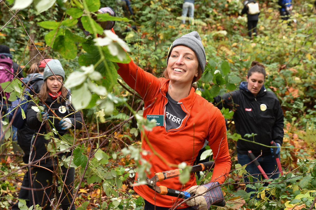 A volunteer helps restore her local park