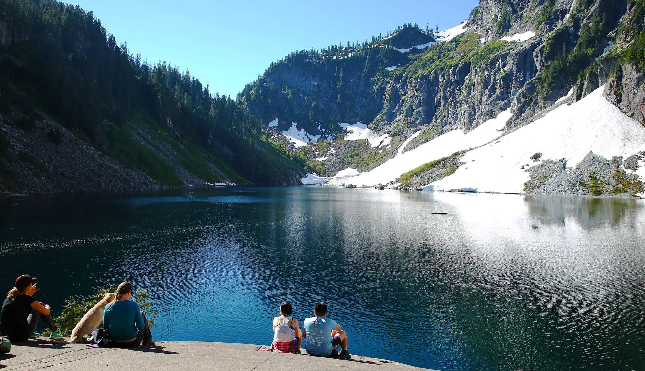 hikers admiring lake serene