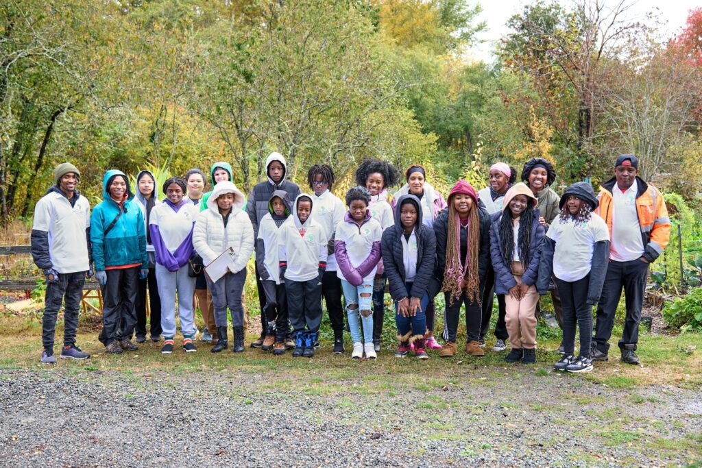 A crowd of people outdoors posing for a photo.