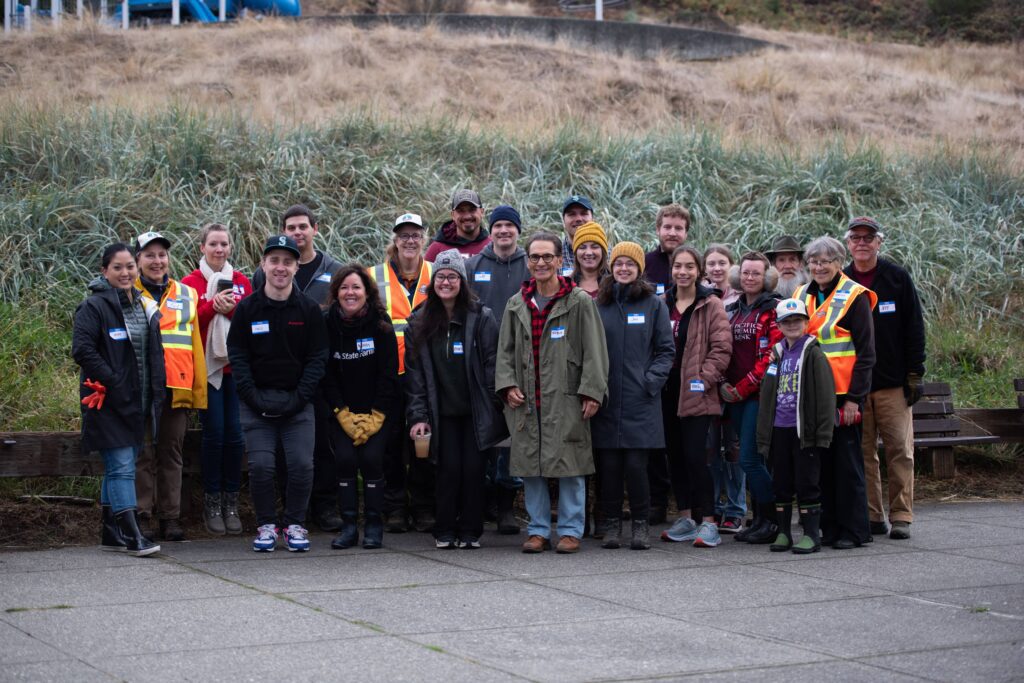 A very large crowd of people standing outside posing for a photo.