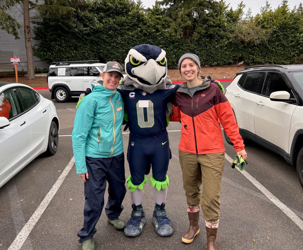 Blitz the Seahawks mascot poses with Forterra team members Courtney and Ash