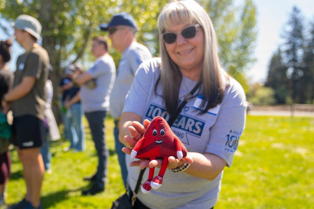 A volunteer holding a Delta Airlines stuffy, participating in a Forterra's land conservation event.