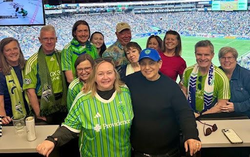 A pictures of Forterra's board and staff members at a Seattle Sounders game.