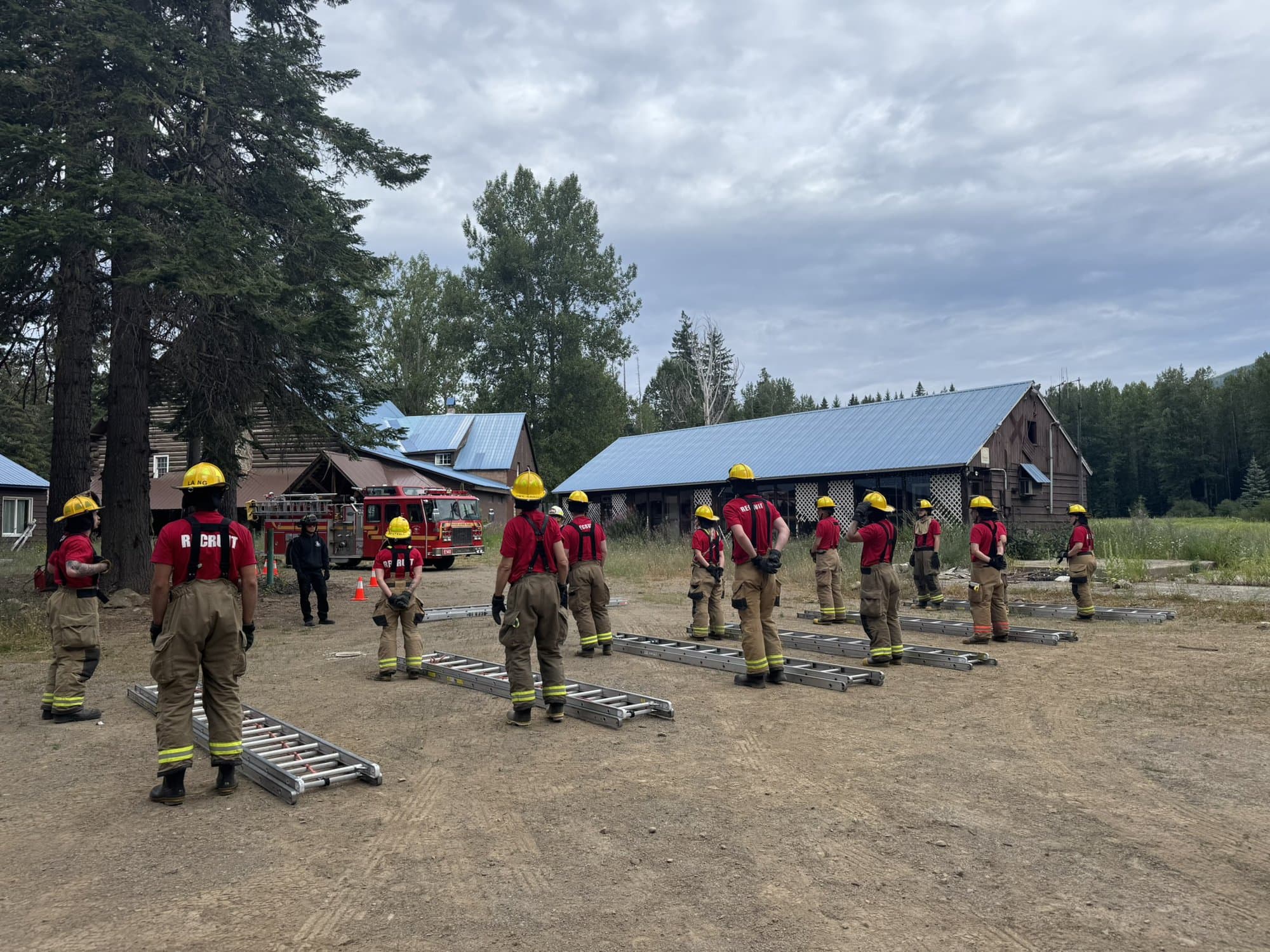 Firefighters outside Kachess lodge surrounded by ladders.