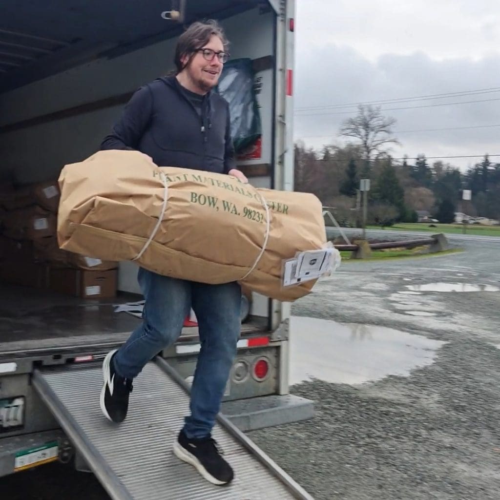 Forterra's Project Manager Daniel Hatchet unloading a soon-to-be-planted tree from the delivery truck.