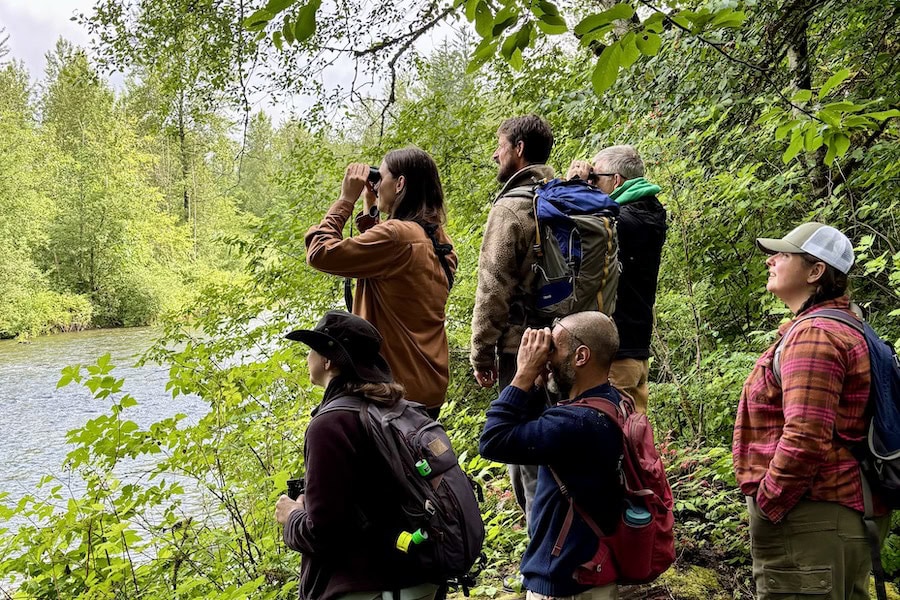 A picture of people looking across a river at Osprey Park.