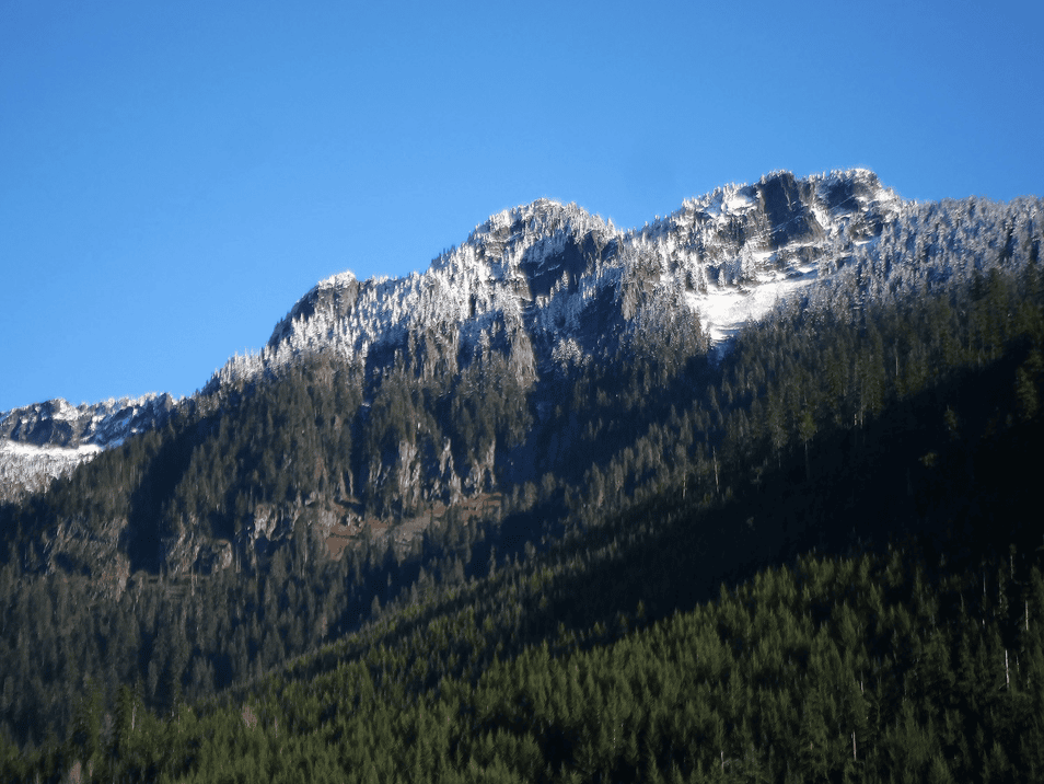 Snowcapped peak rise above Gold Creek Valley, part of the Okanogan-Wenatchee National Forest and the headwaters of the Yakima River. Photo by Chris Walter.